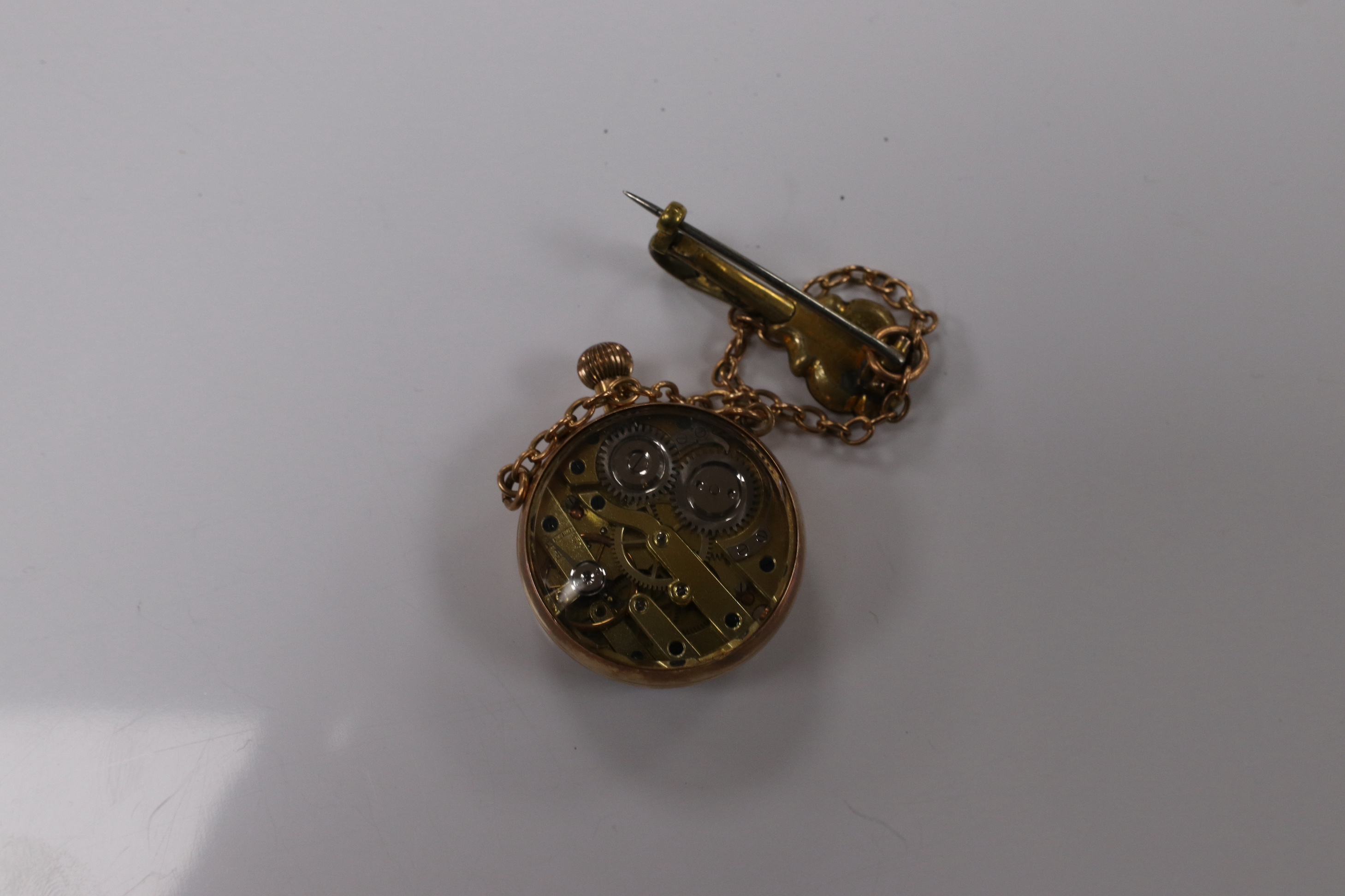 A lady's yellow metal mounted fob watch, with Roman dial and suspension chain with brooch, case diameter 26mm. Condition - fair